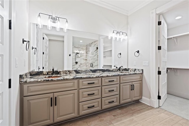 bathroom with crown molding, vanity, an enclosed shower, and hardwood / wood-style flooring