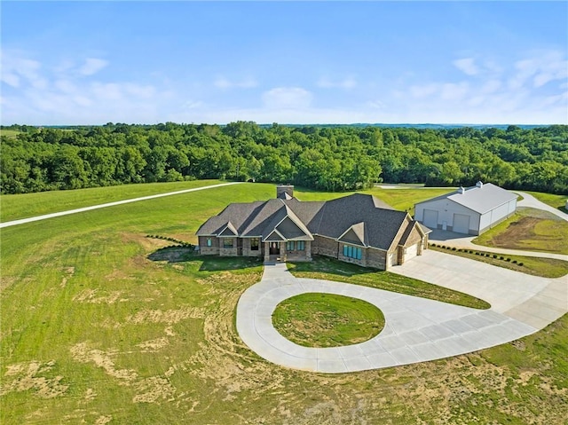 drone / aerial view featuring a wooded view