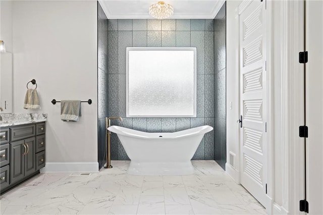 bathroom featuring a freestanding tub, marble finish floor, crown molding, and vanity