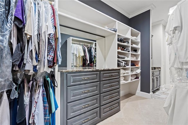 walk in closet featuring light colored carpet