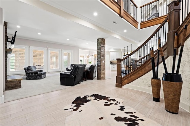 living room featuring decorative columns, recessed lighting, ornamental molding, baseboards, and stairs