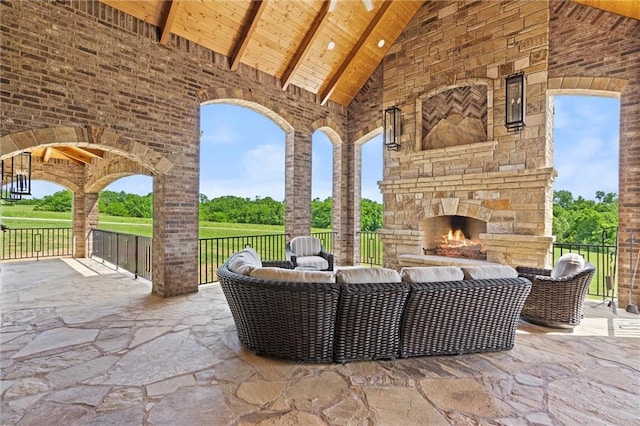 view of patio featuring an outdoor living space with a fireplace and fence