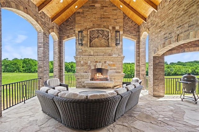 view of patio / terrace featuring a grill and an outdoor living space with a fireplace