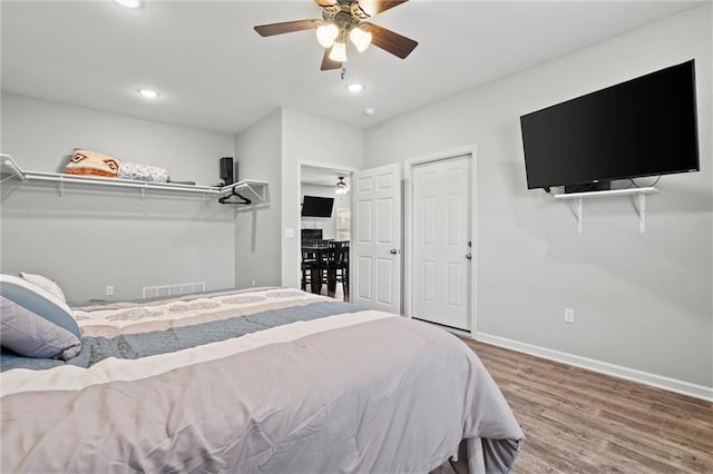 bedroom featuring recessed lighting, visible vents, baseboards, and wood finished floors