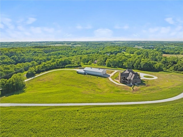 birds eye view of property featuring a forest view