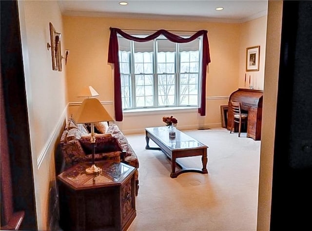 carpeted living room with ornamental molding