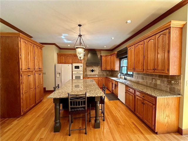 kitchen featuring light hardwood / wood-style floors, a kitchen island, white appliances, tasteful backsplash, and custom exhaust hood