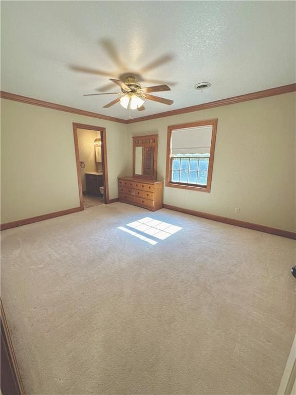 spare room with carpet, ceiling fan, a textured ceiling, and crown molding