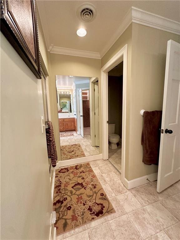 bathroom featuring crown molding, toilet, and tile floors