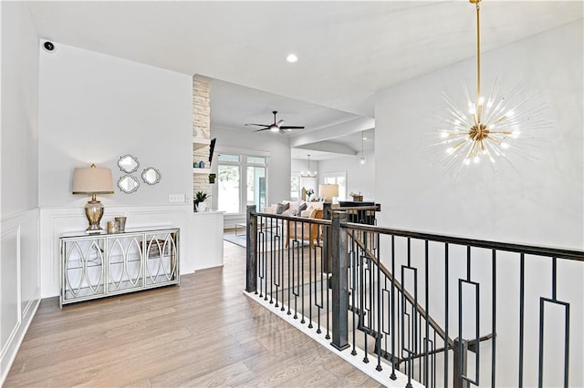 24932 W 98th Pl, Lenexa, KS 66227 - hallway with a chandelier, an upstairs landing, wood finished floors, wainscoting, and recessed lighting