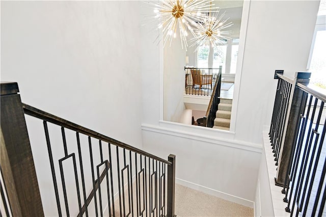 24932 W 98th Pl, Lenexa, KS 66227 - stairway featuring a chandelier, plenty of natural light, and baseboards