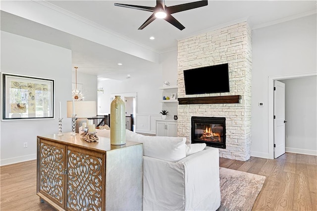 24932 W 98th Pl, Lenexa, KS 66227 - living area featuring crown molding, wood finished floors, ceiling fan, baseboards, and a fireplace
