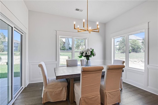 24932 W 98th Pl, Lenexa, KS 66227 - dining area with a chandelier, a decorative wall, dark wood finished floors, and a wainscoted wall