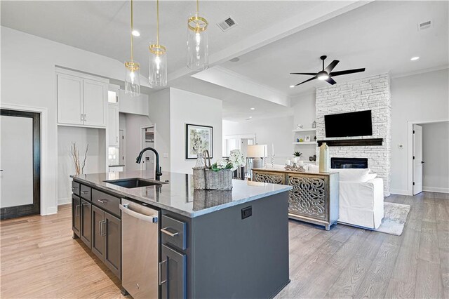 24932 W 98th Pl, Lenexa, KS 66227 - kitchen with a sink, stainless steel dishwasher, a ceiling fan, dark stone countertops, and white cabinetry