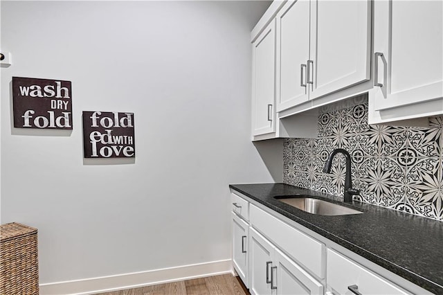 24932 W 98th Pl, Lenexa, KS 66227 - kitchen with a sink, decorative backsplash, baseboards, and white cabinets