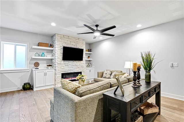 24932 W 98th Pl, Lenexa, KS 66227 - living room featuring ceiling fan, a stone fireplace, light wood-style floors, baseboards, and recessed lighting