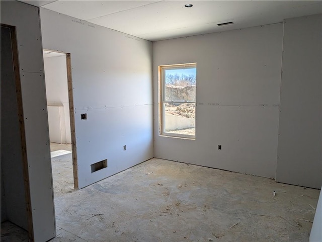 unfurnished room with visible vents