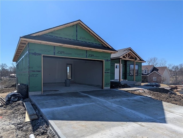 property in mid-construction with concrete driveway and an attached garage