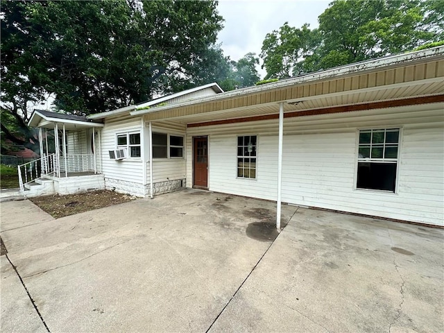 rear view of house featuring cooling unit