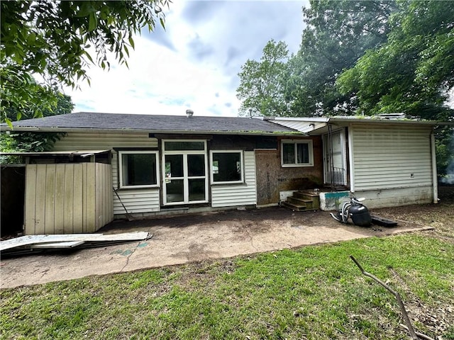 321 Pecan St, Chetopa, KS 67336 - back of house featuring a patio and a lawn