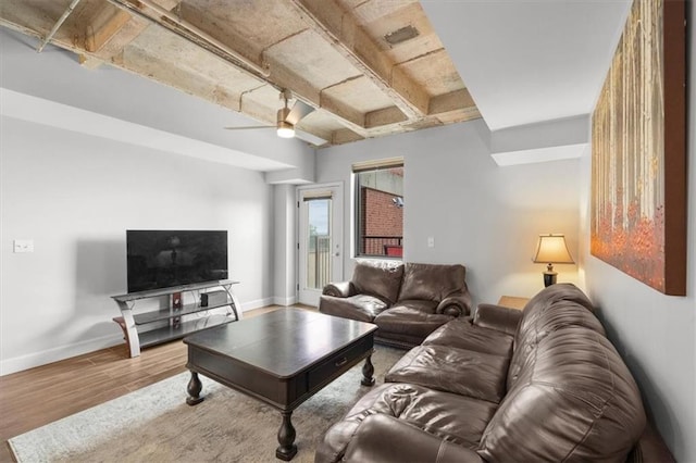 2980 Baltimore Ave Unit 2204, Kansas City, MO 64108 - living room featuring wood finished floors, baseboards, ceiling fan, and beamed ceiling