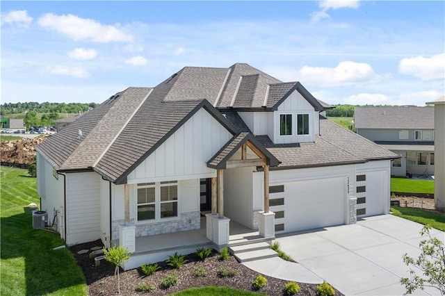 view of front of house featuring a garage and central AC