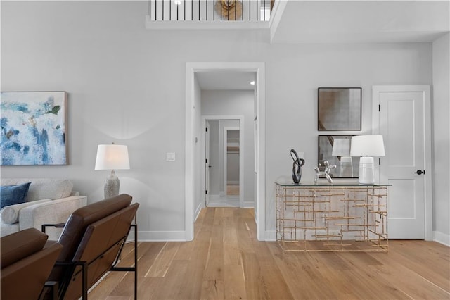 hall with wood finished floors and baseboards