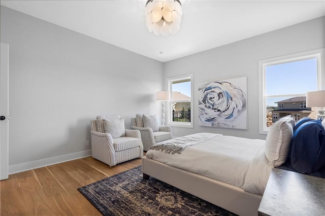 bedroom with wood finished floors and baseboards