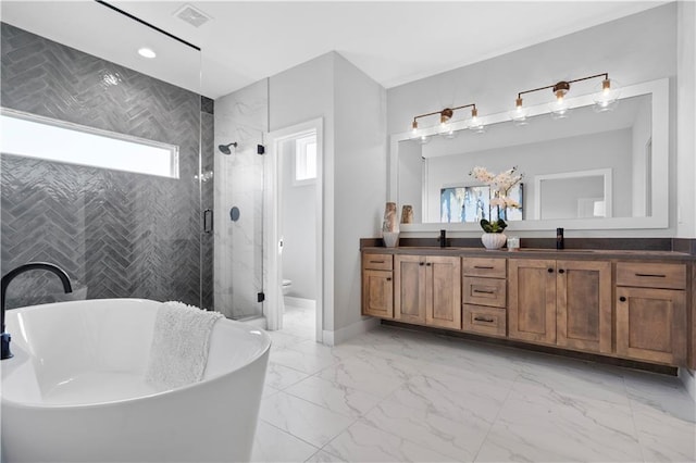 full bathroom with a sink, visible vents, marble finish floor, a shower stall, and double vanity