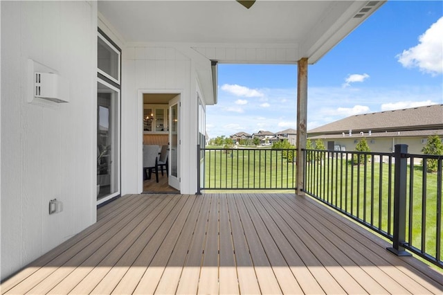 wooden terrace featuring a residential view and a lawn