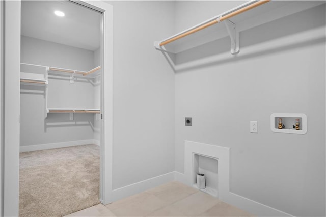 washroom with hookup for an electric dryer, laundry area, washer hookup, baseboards, and carpet