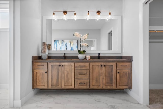 bathroom with a wealth of natural light, marble finish floor, and a sink