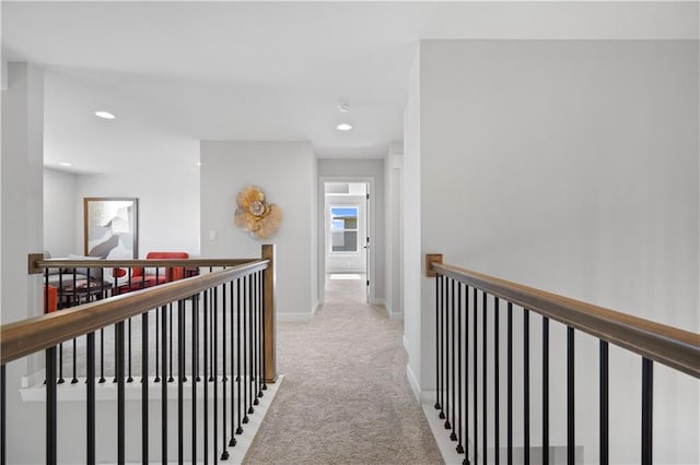 corridor featuring recessed lighting, carpet flooring, an upstairs landing, and baseboards