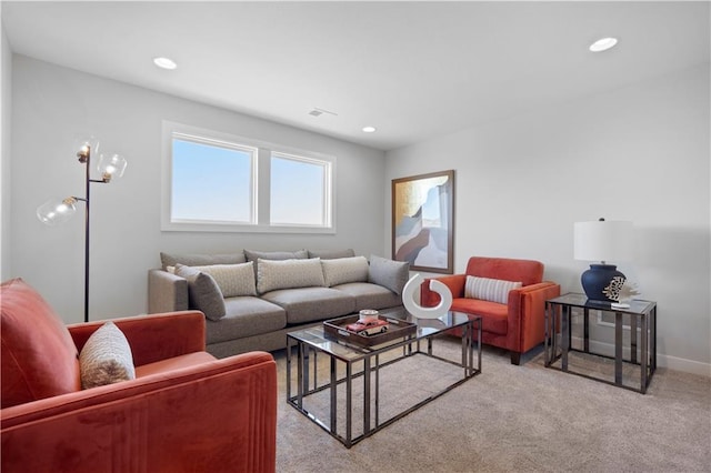 living area with recessed lighting, light colored carpet, and baseboards