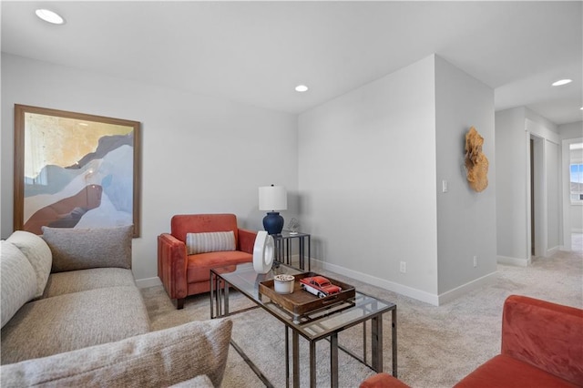 carpeted living area with baseboards and recessed lighting