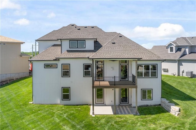 rear view of house with a shingled roof, a lawn, a patio area, and central air condition unit