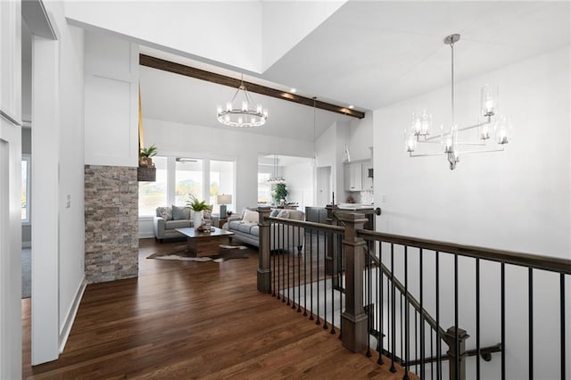 corridor with beam ceiling, high vaulted ceiling, an inviting chandelier, and dark hardwood / wood-style floors