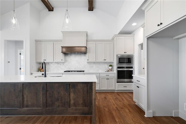 kitchen featuring hanging light fixtures, appliances with stainless steel finishes, white cabinetry, and sink