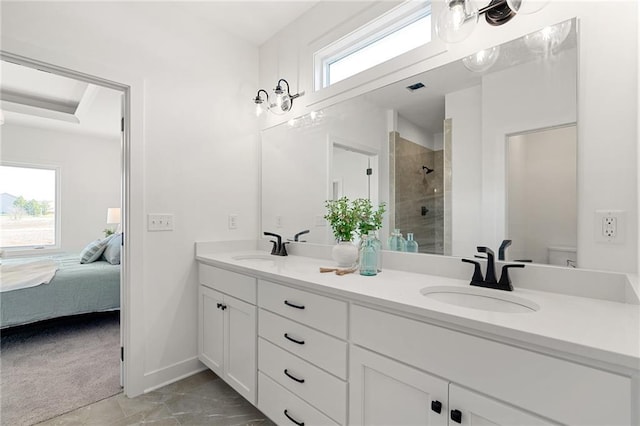 bathroom with a tile shower, vanity, and toilet