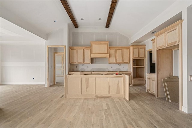 kitchen featuring light brown cabinetry, a kitchen island, beamed ceiling, high vaulted ceiling, and light wood-style flooring