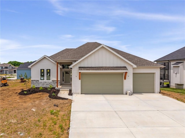 9346 Gander St, Lenexa, KS 66227 - view of front of house with an attached garage, roof with shingles, driveway, and board and batten siding