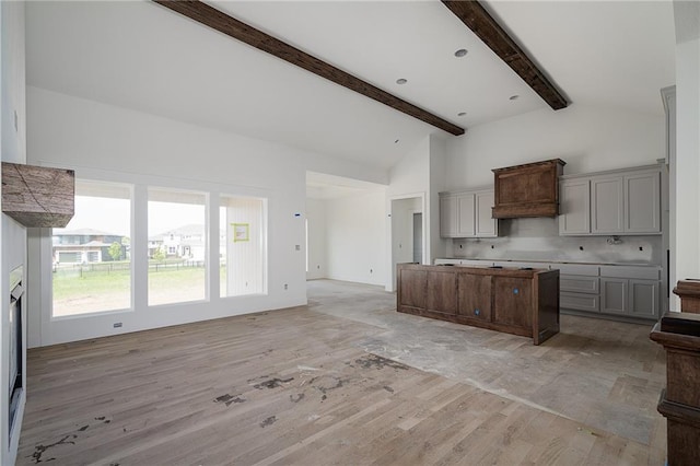 9346 Gander St, Lenexa, KS 66227 - kitchen with a center island, open floor plan, light wood finished floors, beam ceiling, and gray cabinetry