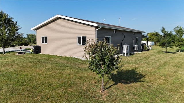 view of side of home featuring a lawn