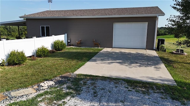 garage featuring driveway and fence