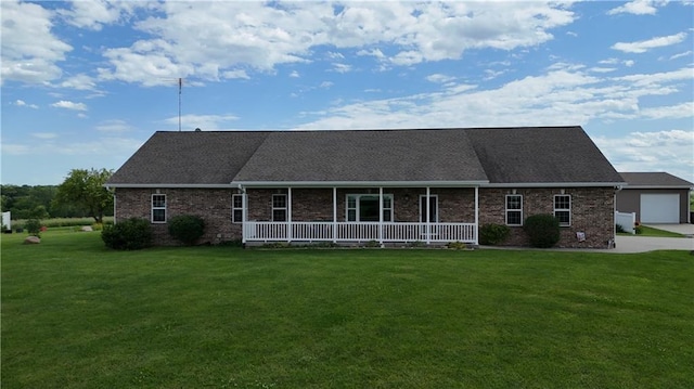 view of front of home featuring brick siding, roof with shingles, a porch, and a front yard