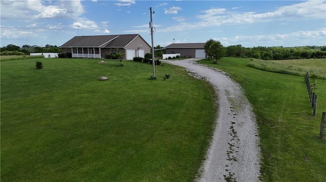 single story home featuring a garage, driveway, and a front lawn