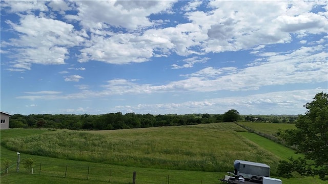 exterior space with a rural view and fence