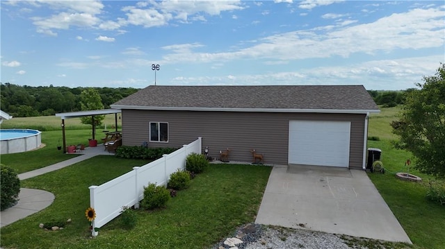 view of property exterior with a fenced in pool, a lawn, fence, a garage, and driveway