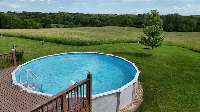 outdoor pool featuring a deck and a yard