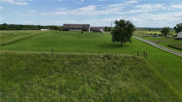 exterior space with fence and a rural view